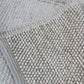 handwoven chunky loop wool rug corner detail beige cream bordered edge natural wool pile close up Lav and Lira