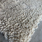 White plush shaggy wool area rug laid flat showing full chunky loop weave pattern, custom sizes available