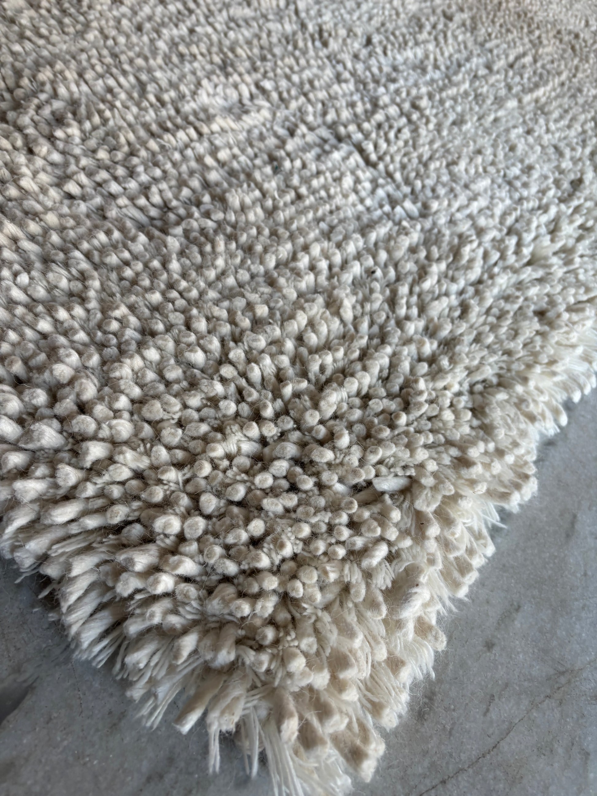 White plush shaggy wool area rug laid flat showing full chunky loop weave pattern, custom sizes available