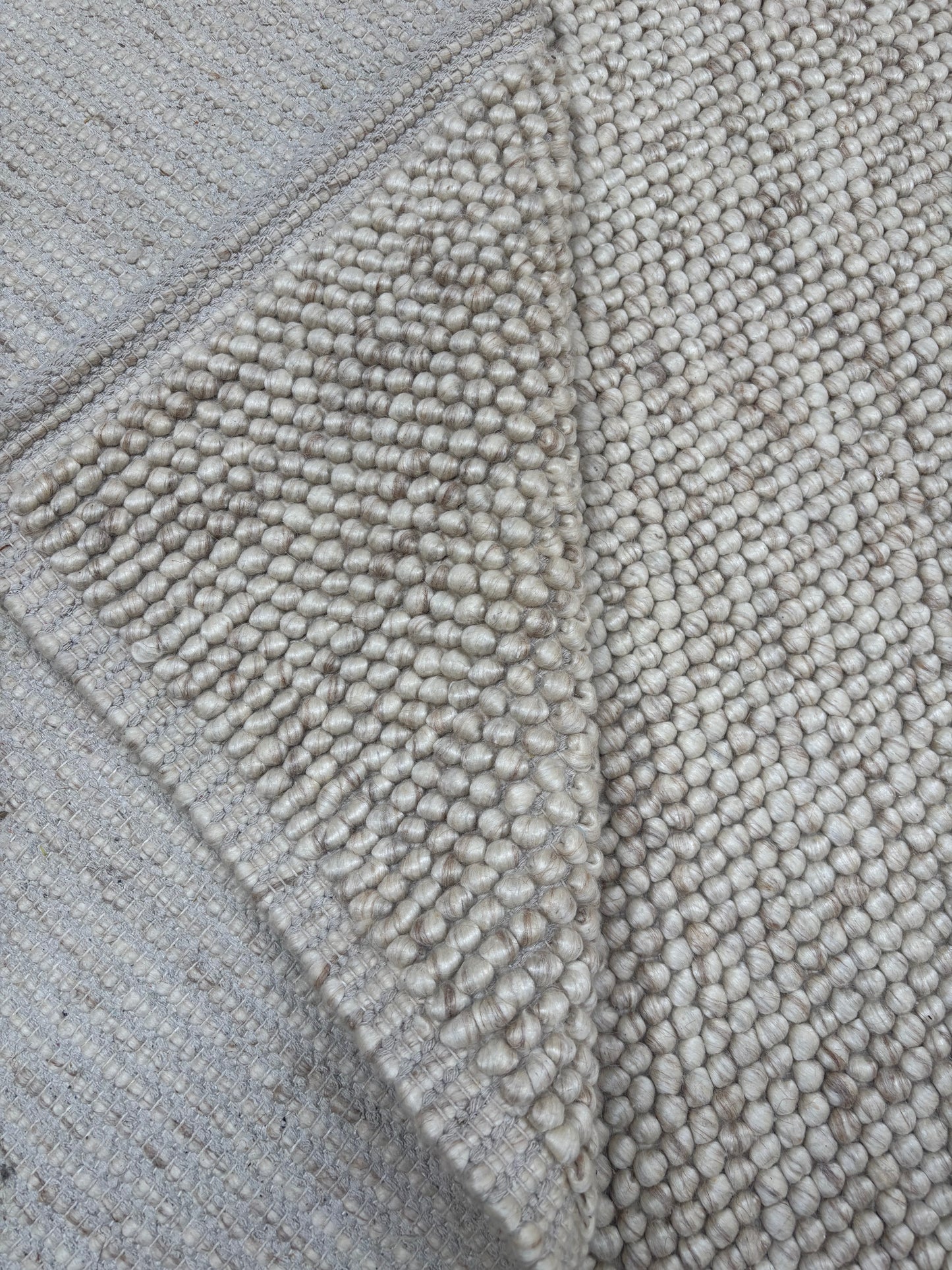 handwoven chunky loop wool rug 8x10 beige cream bordered natural wool area rug living room scale Lav and Lira