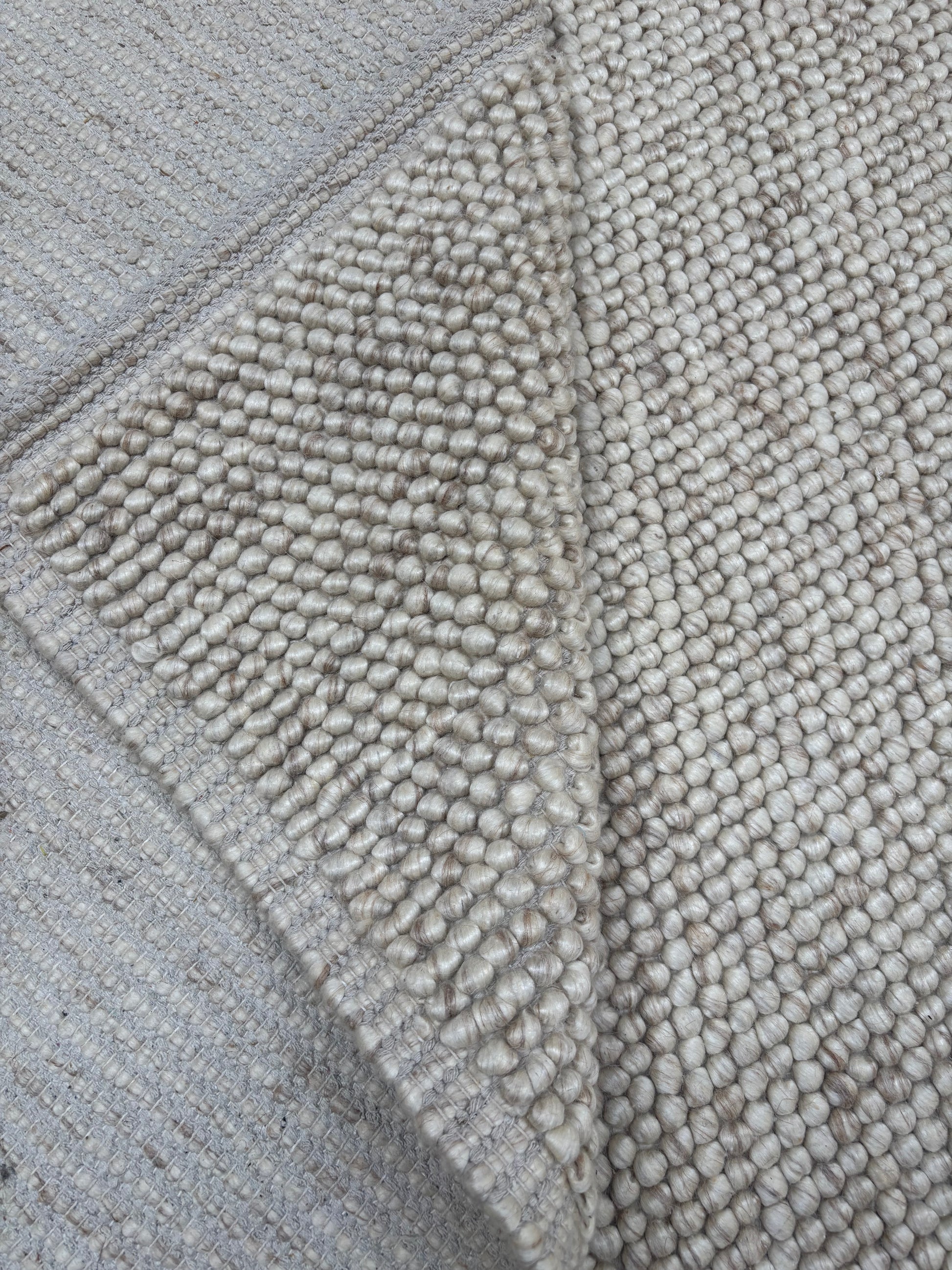 handwoven chunky loop wool rug 8x10 beige cream bordered natural wool area rug living room scale Lav and Lira