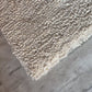 Video showing the plush texture and quality of handwoven white wool shaggy rug by LavnLira, custom made in Varanasi